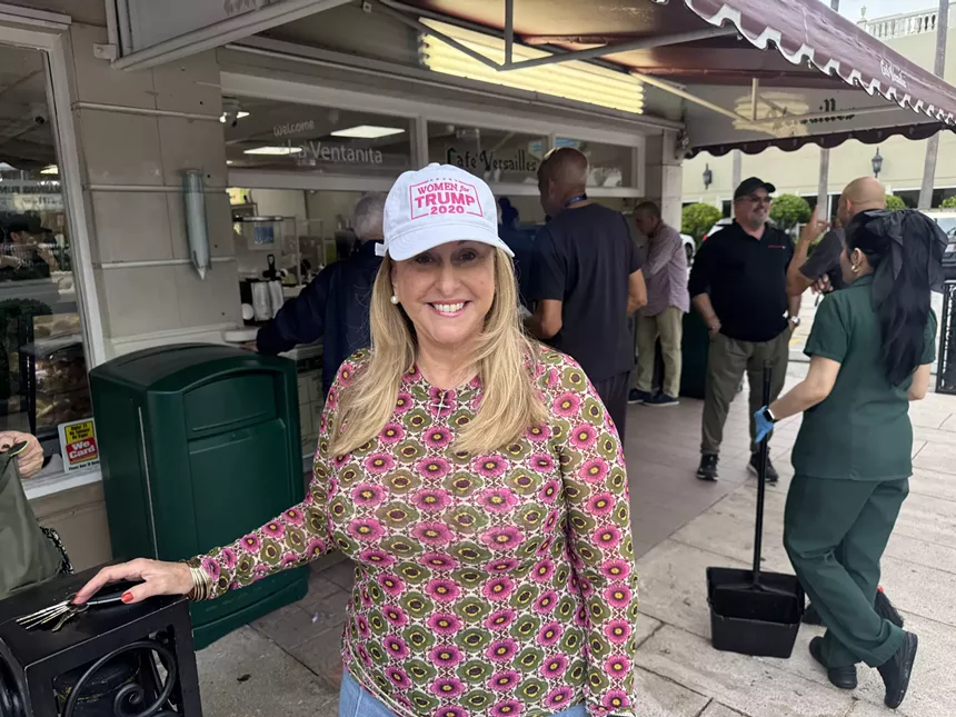 A woman in a Trump cap