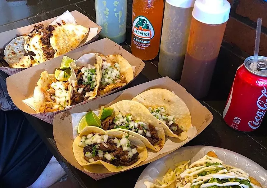 tacos in a line on a plate