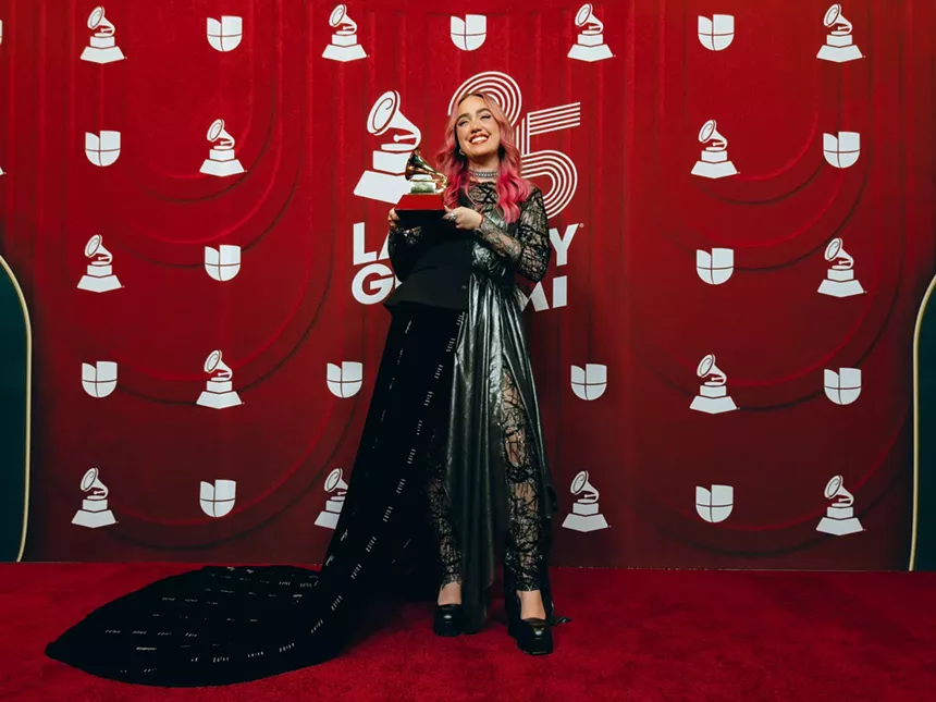 Ela Taubert holding her trophy backstage at the Latin Grammys