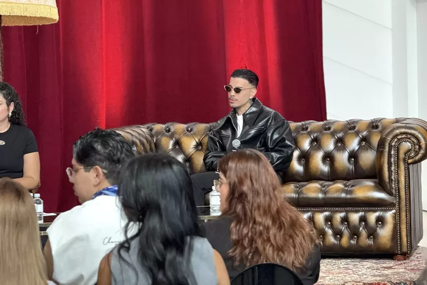 Rauw Alejandro onstage speaking about his new album