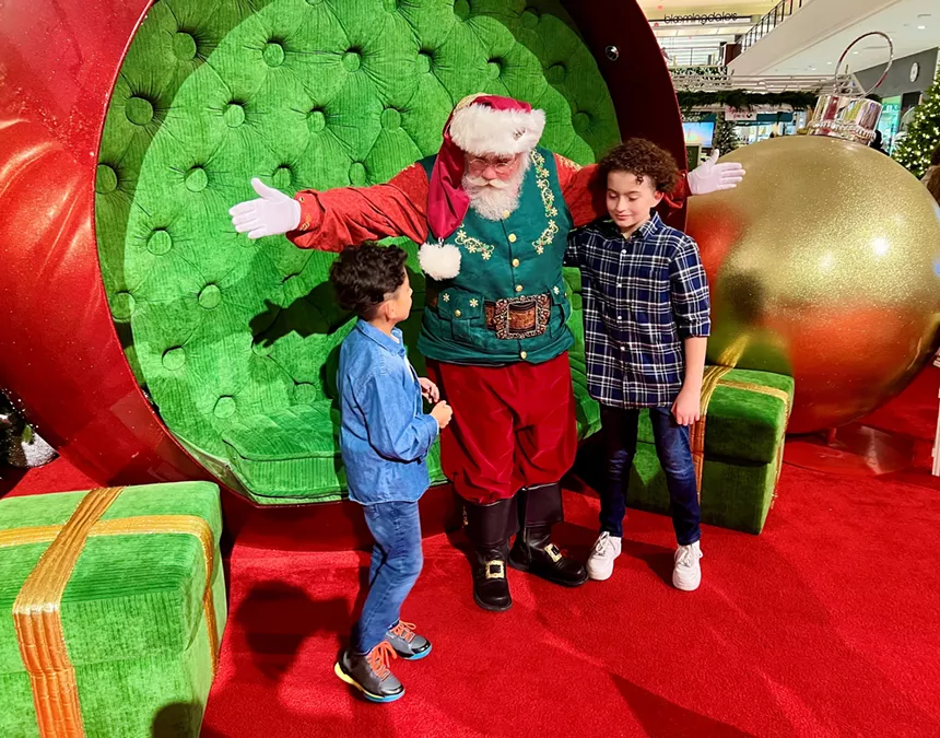 Children posing with Santa Claus at Aventura Mall
