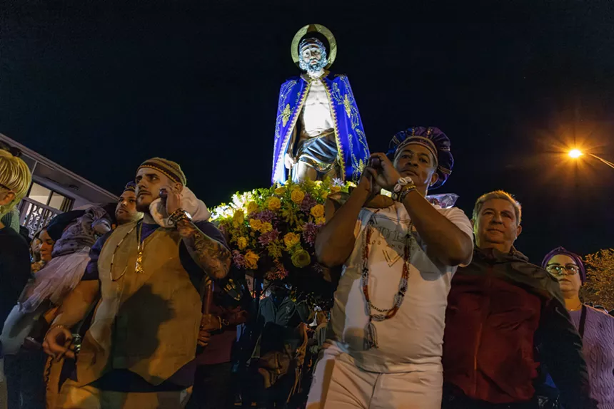A photo by Woosler Delisfort showcasing a St. Lazarus parade in Hialeah with Cuban heritage devotees honoring the patron spirit
