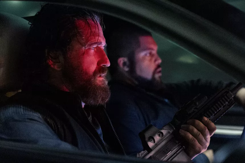 Gerard Butler and O'Shea Jackson Jr. in a car with guns
