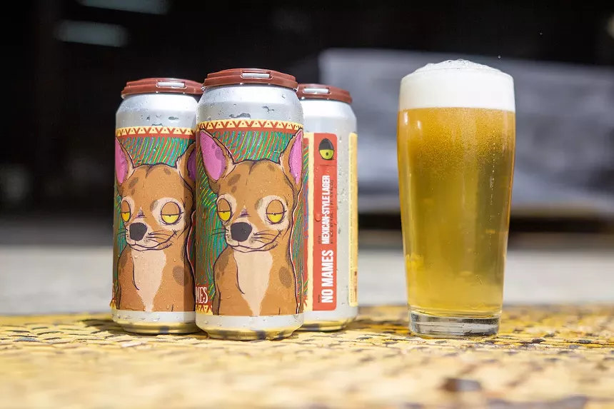 cans of beer next to a glass of beer