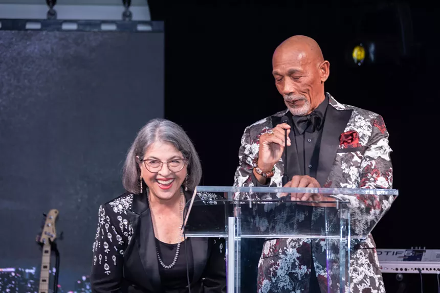 Eric Knowles and Mayor Daniella Levine Cava at a podium during the Miami-Dade Chamber of Commerce’s gala