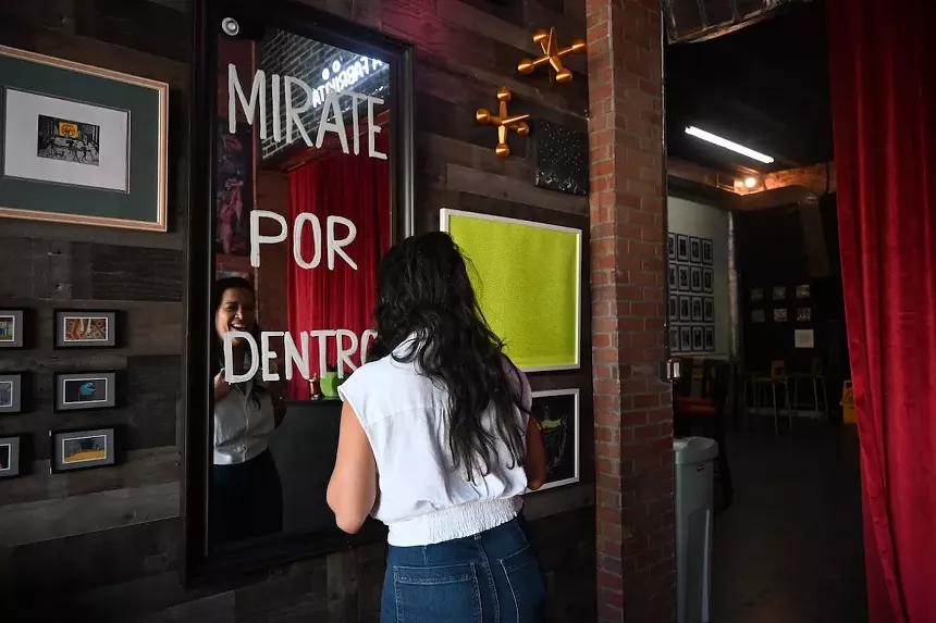 DJ Pati staring a mirror inside La Fabrikita in Miami's Little Havana neighborhood