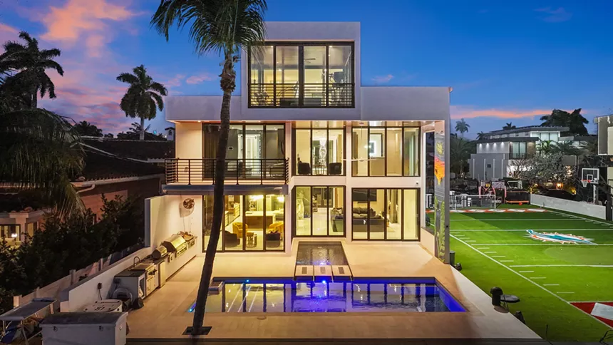 Backyard shot of three-story mansion in Fort Lauderdale