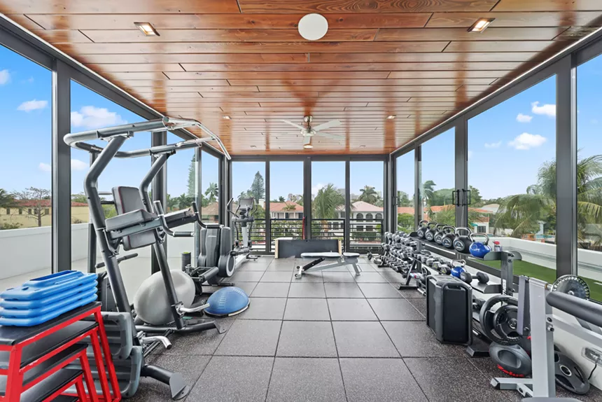Third-floor gym complete with floor-to-ceiling glass windows overlooking Fort Lauderdale