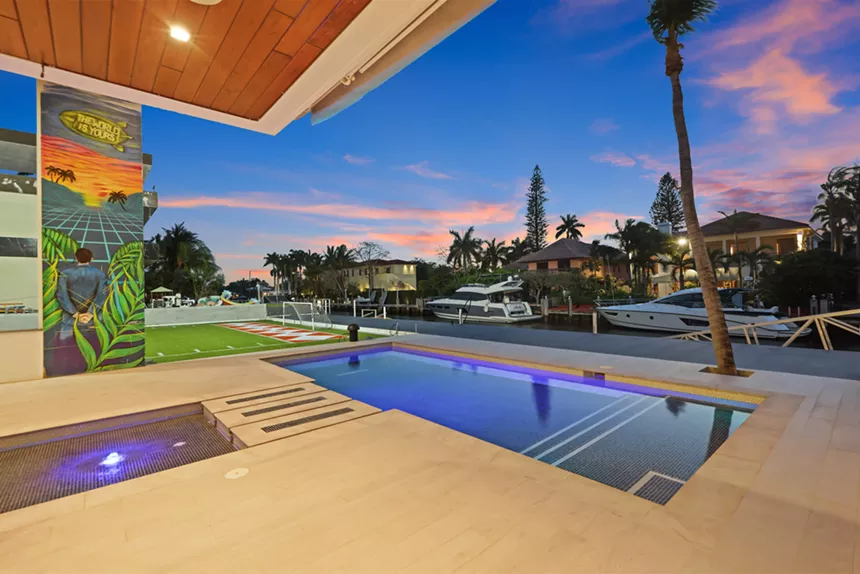Backyard of the Fort Lauderdale mansion looks toward the water and overlooks the pool