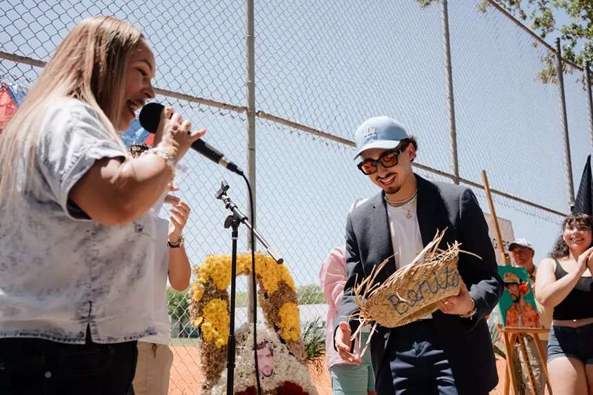 man dressed like Bad Bunny holds a straw