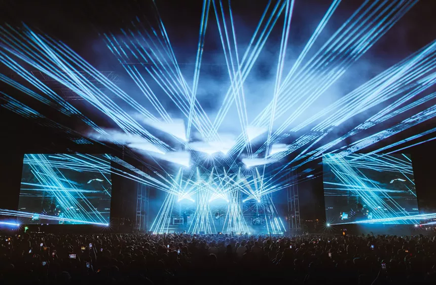 a laser light show at an outdoor EDM concert