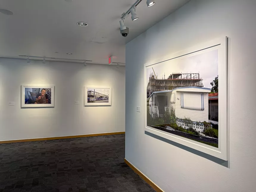 a series of framed photos on display in a gallery