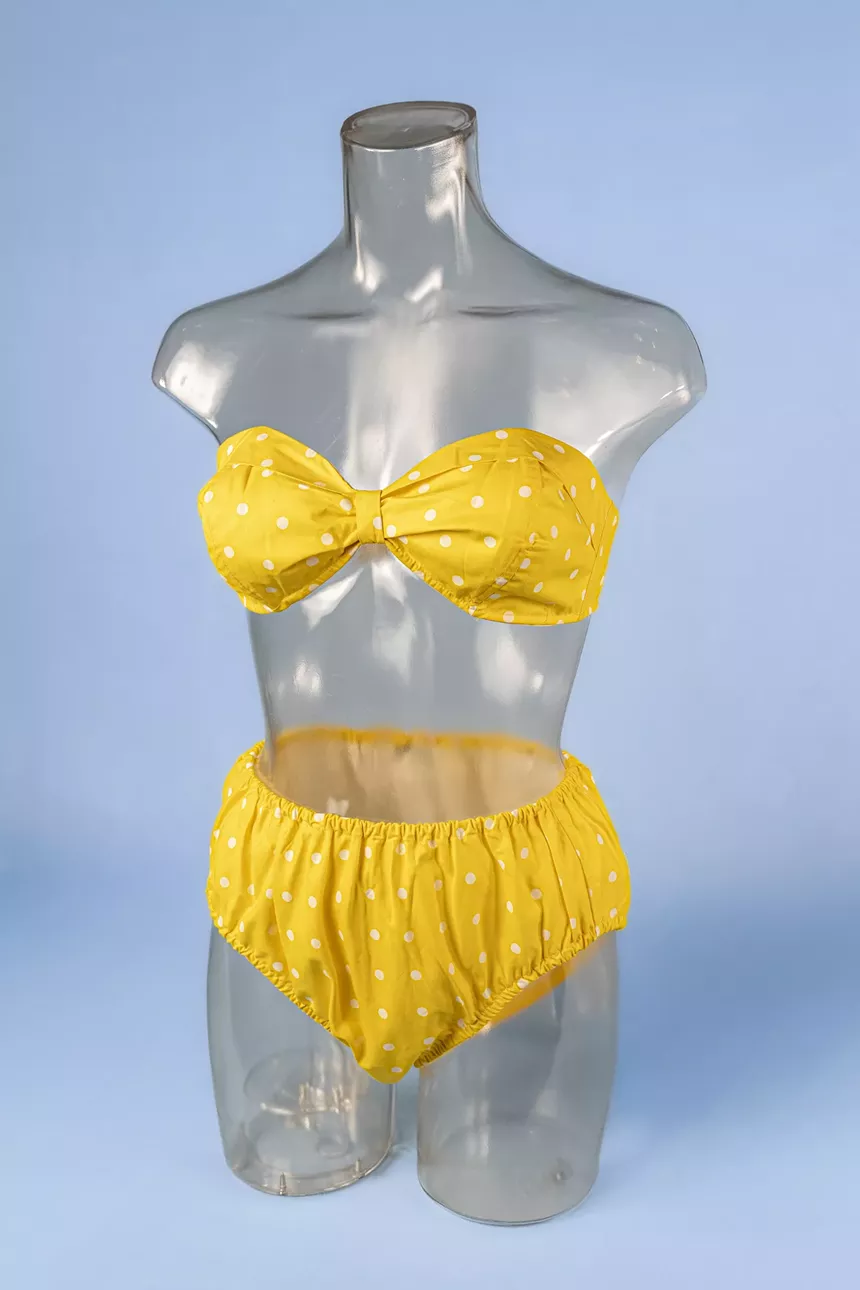 '60s-era yellow polka-dot swimsuit on a mannequin
