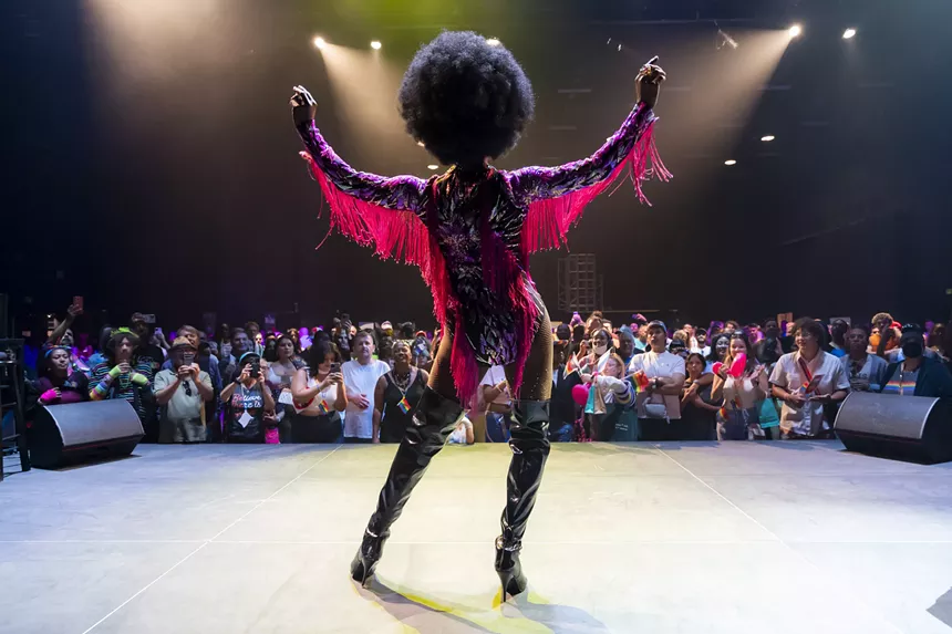 back view of a drag queen performing onstage
