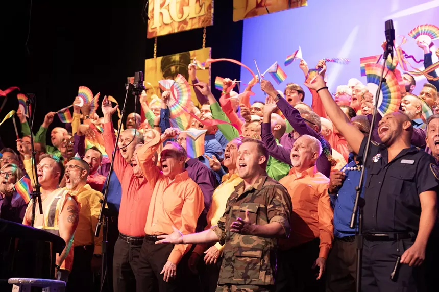 The Gay Men’s Chorus of South Florida performs and waves rainbow flags