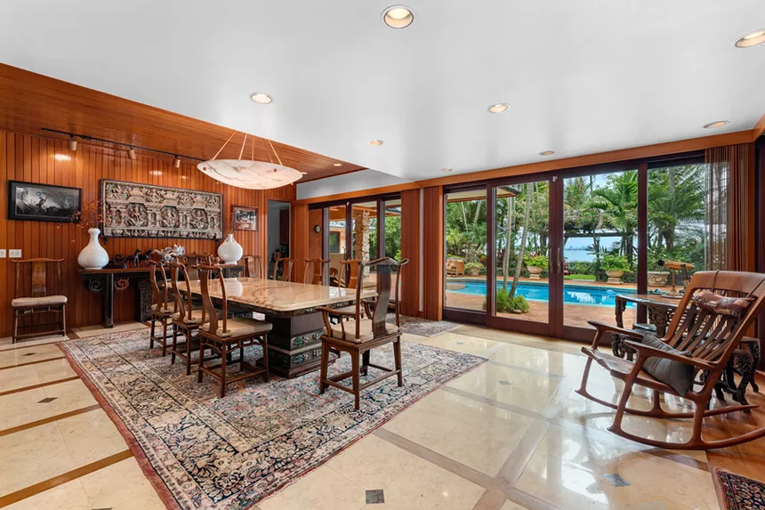 dinging area with view of the backyard and pool