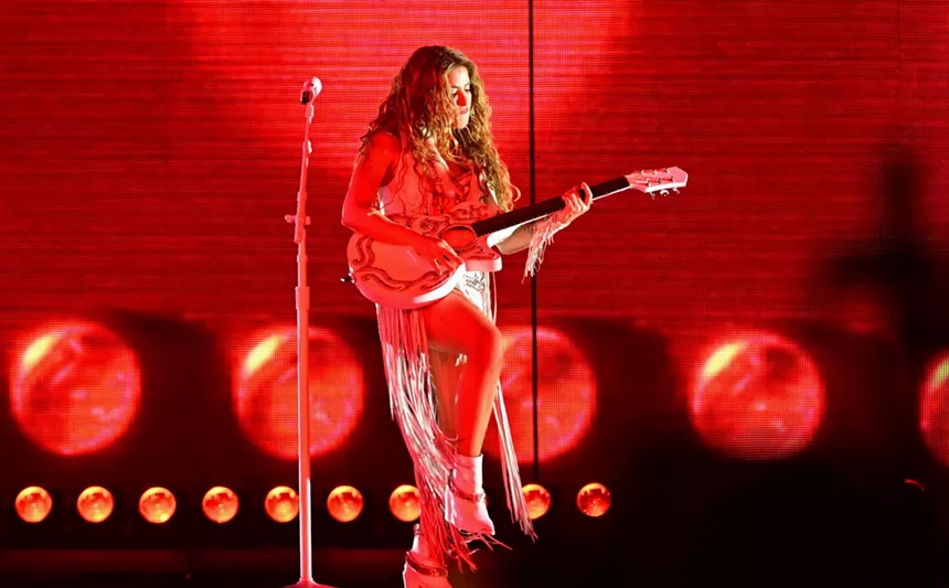 Shakira playing guitar onstage at Hard Rock Stadium