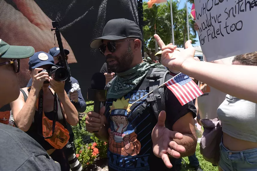 A far-right activist talks to anti-Trump protesters while facing backlash.