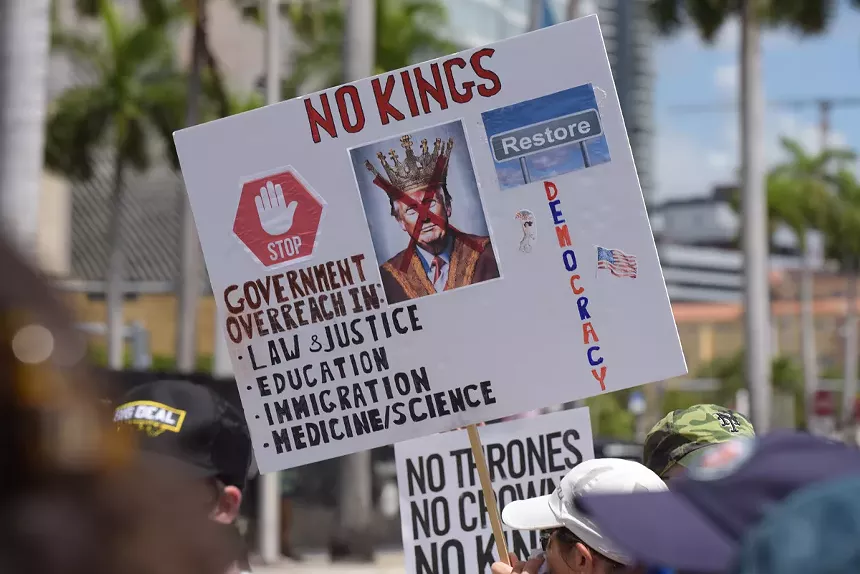 A sign complains that President Donald Trump's administration is overreaching in many areas.