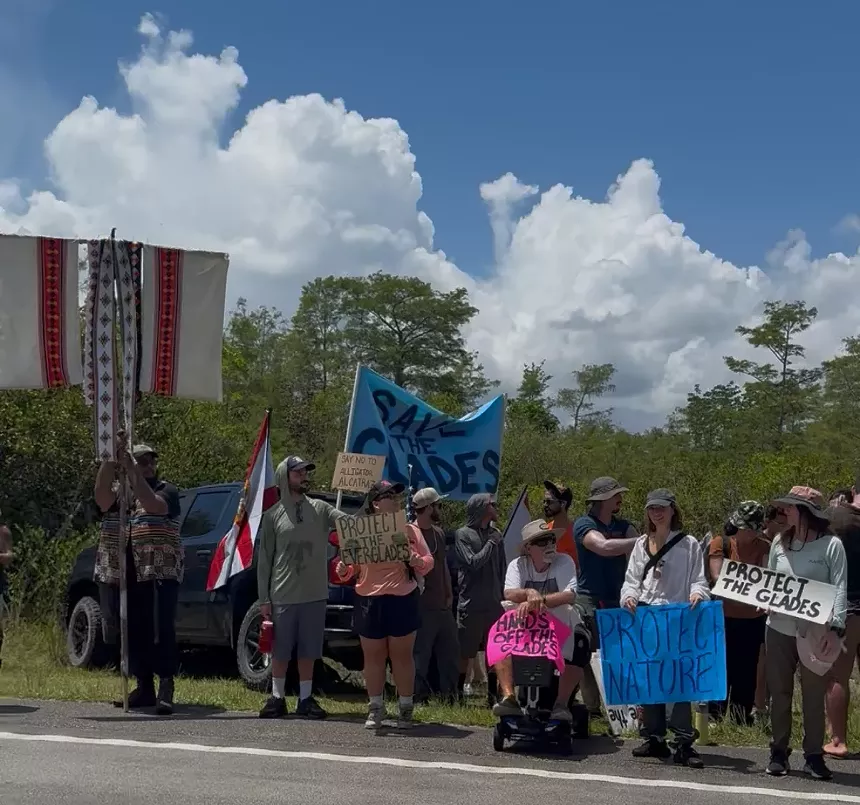 A photo of protesters outside Dade-Collier Training and Transition Airport.