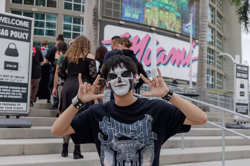 A black metal fan with his face painted