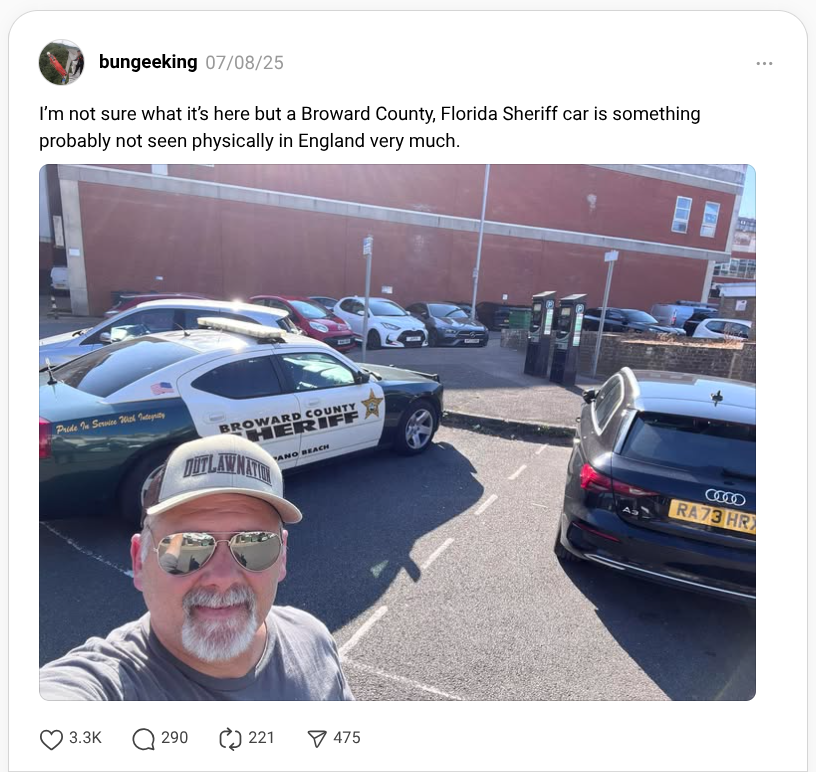Rodney Price poses for a photo showing a Broward County Sheriff’s Office (BSO) cruiser in England