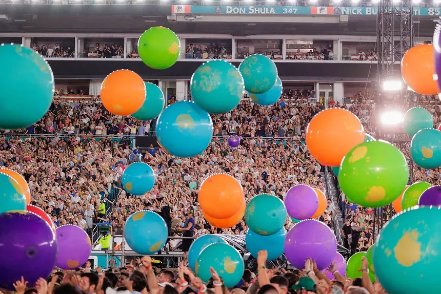giant colorful balls bouncing through the crowd at a concert