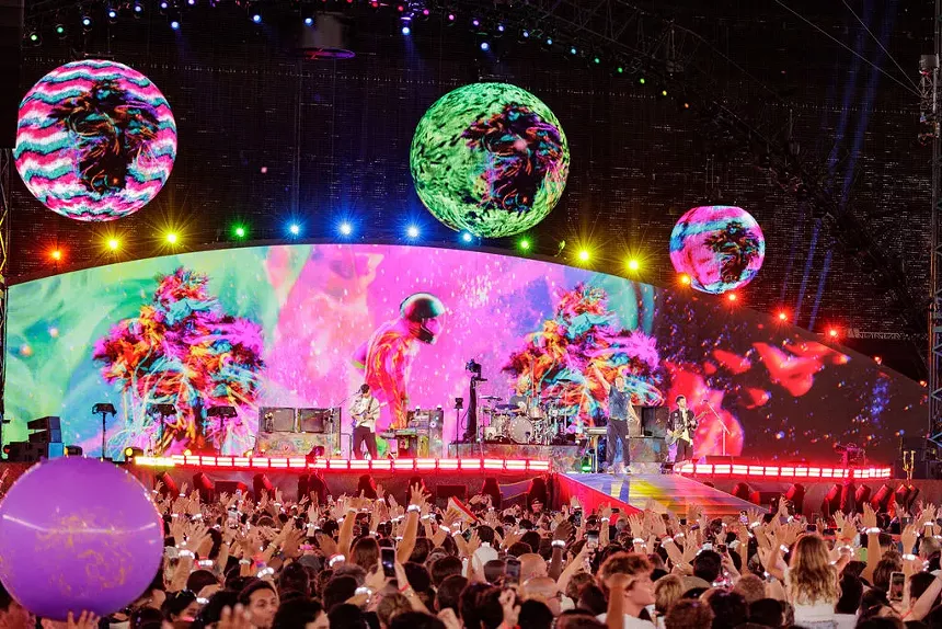 A stadium full of people during a concert.