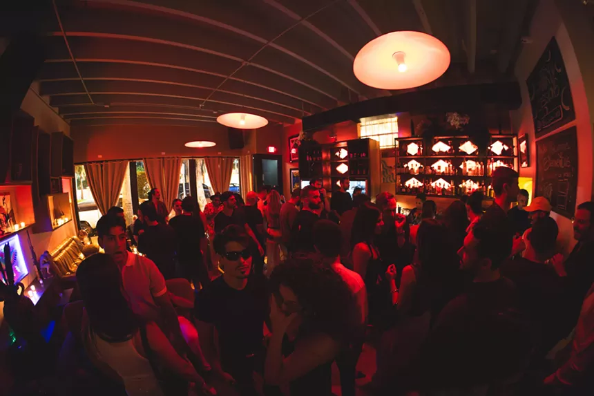 People dancing in a room with red light