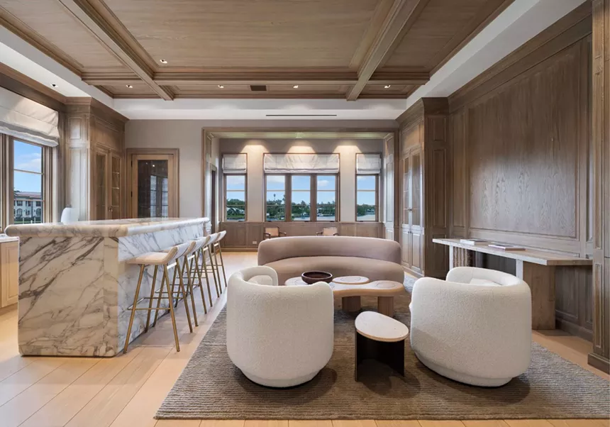 Picture of a living room with brown and white furniture.