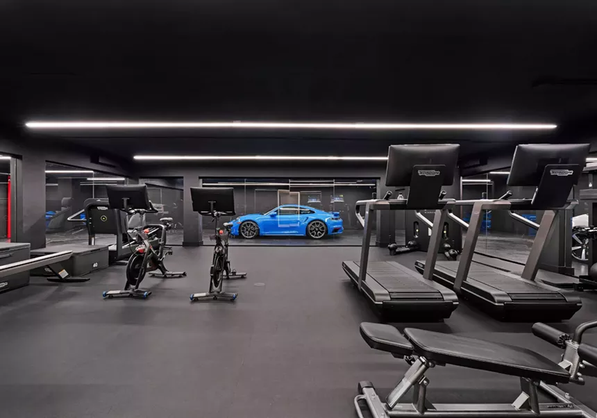 Picture of a blue Porsche in a gym.