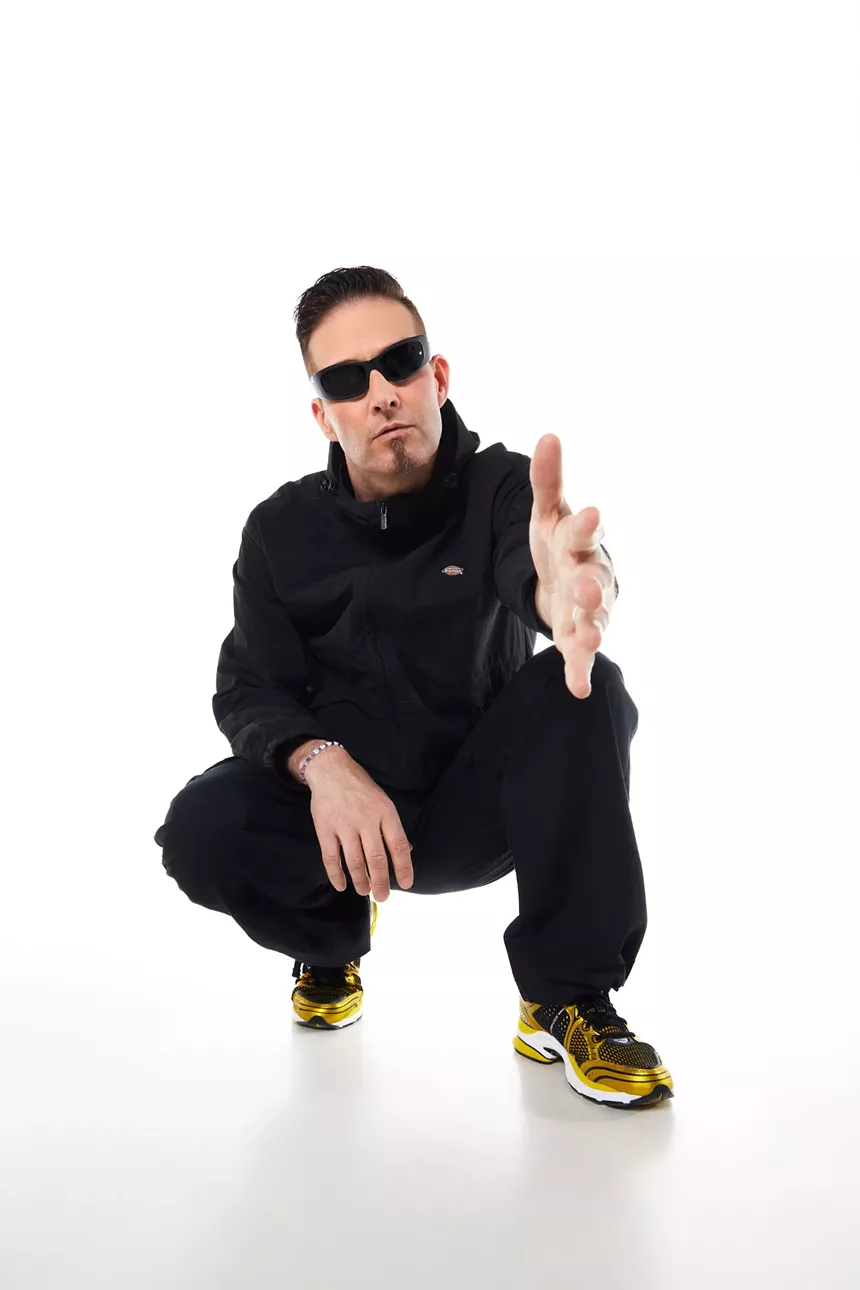 Portrait of a man pointing at the camera against a white background.