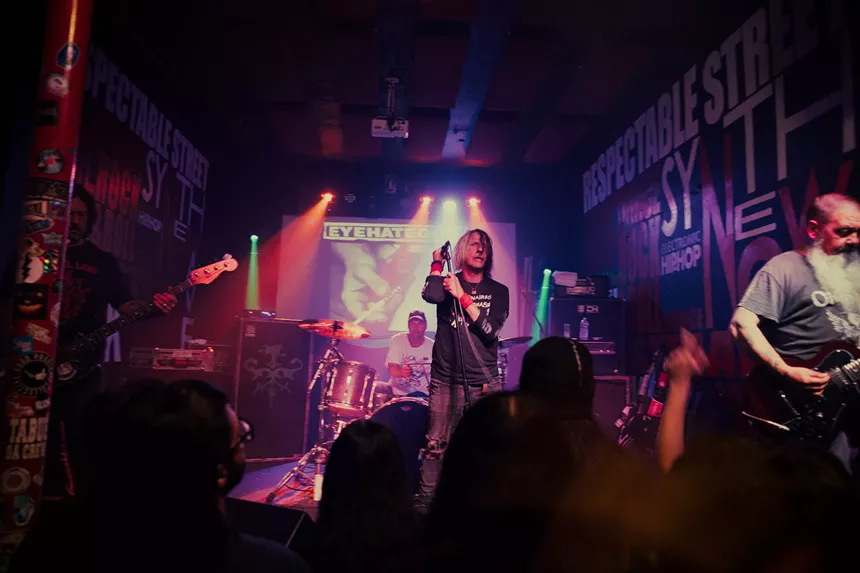 Metal band Eyehategod performing in front of a crowd.