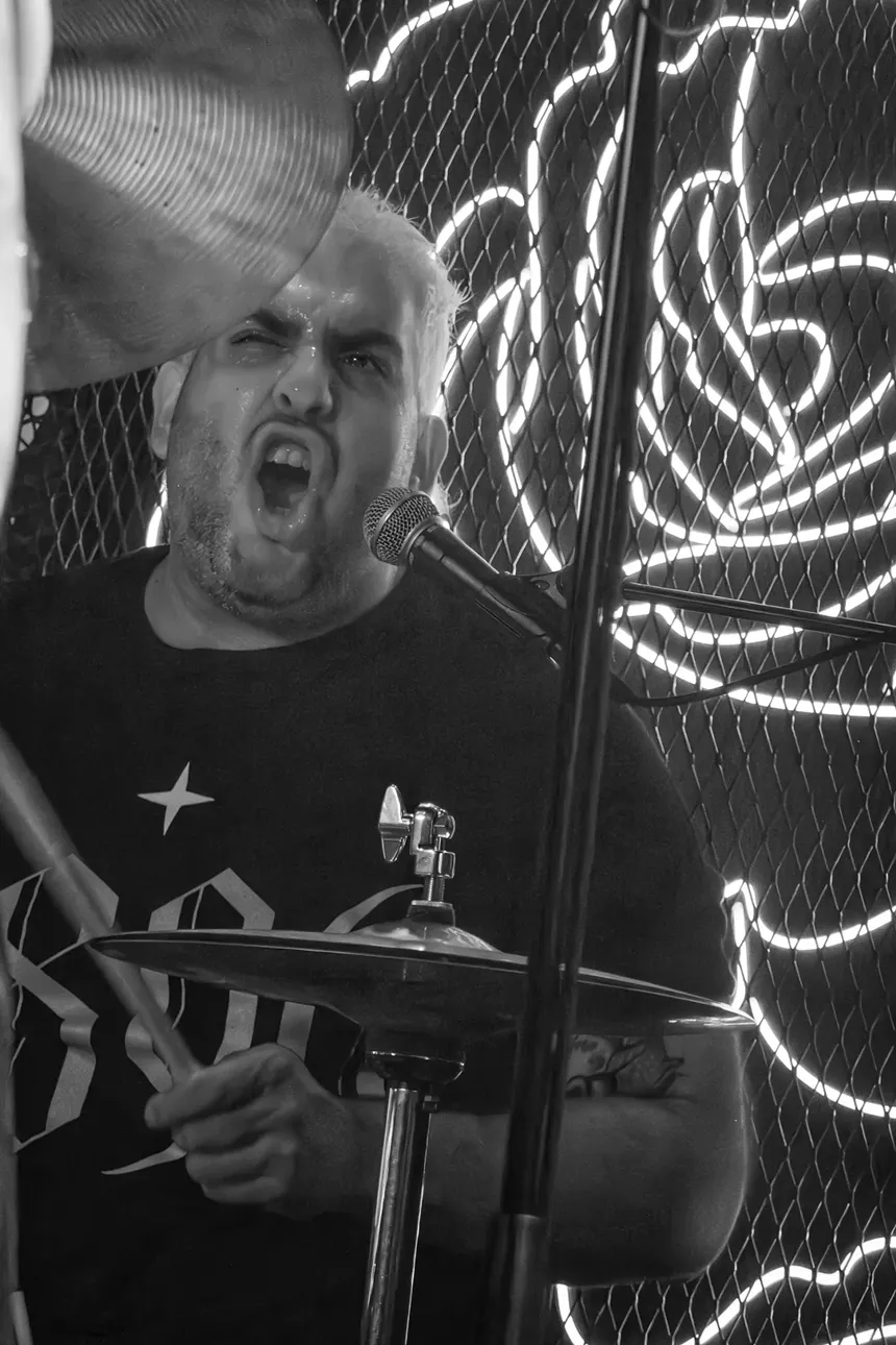 Black and white picture of a drummer performing.