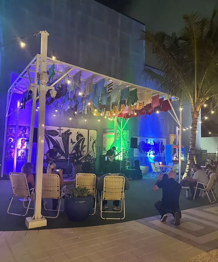 Small stage with a live band performing at night.