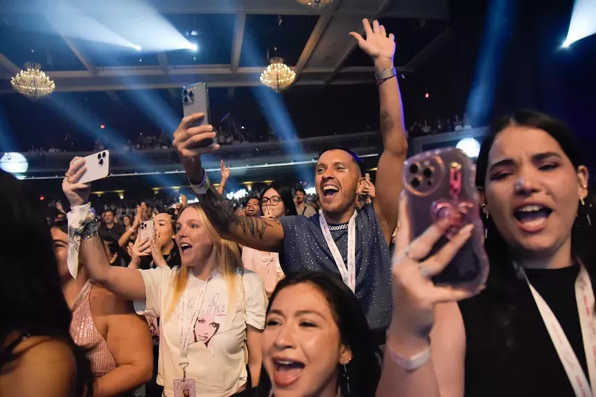A crowd singing at a concert