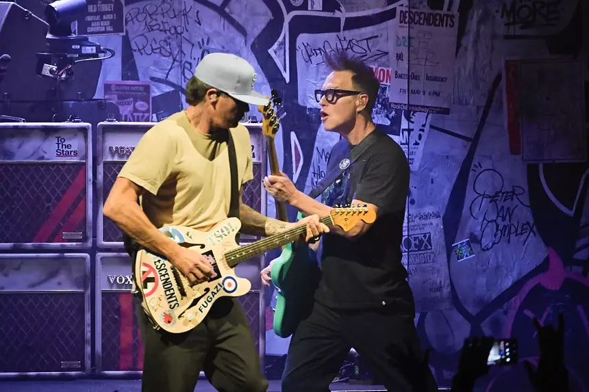 A band performing in a set designed to look like a flyer festooned 200 capacity club.