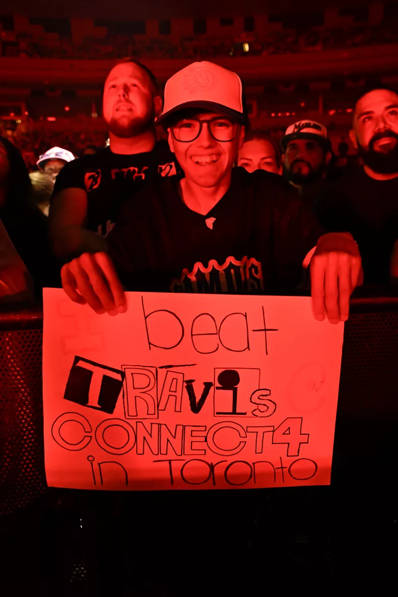 Fan holding a handmade sign at a concert.
