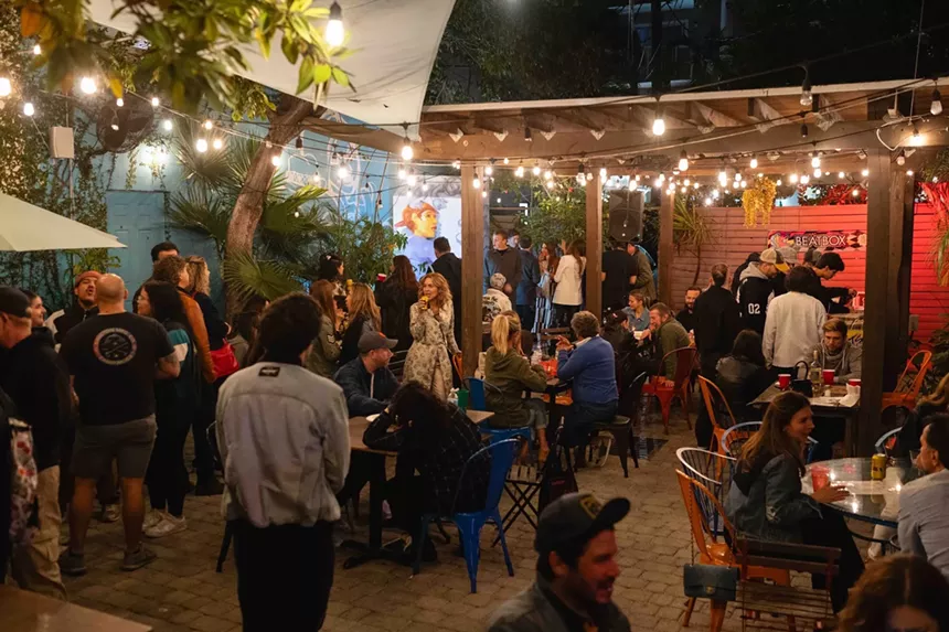 people gather at a backyard at a gallery