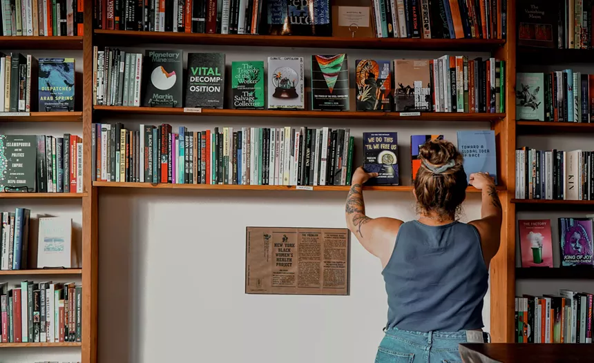 a woman browing books in a bookstore