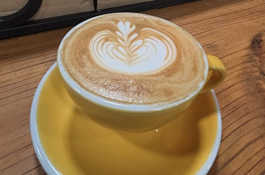 a latte on a wood table