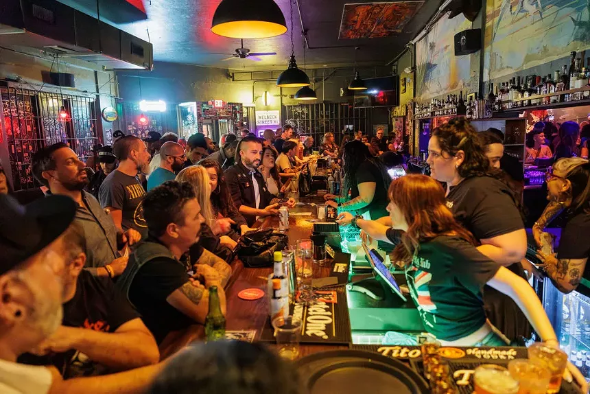 people at a bar waiting to order.