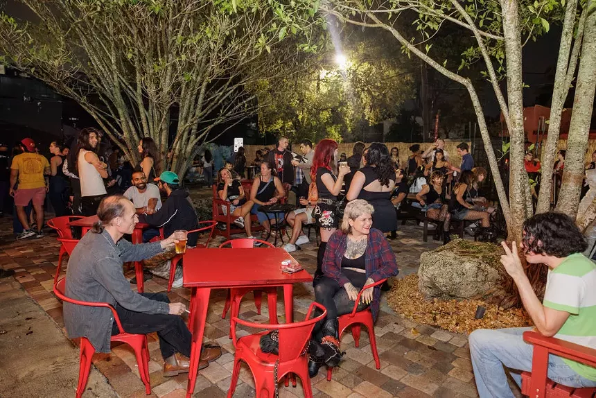 People sitting at a patio in Miami