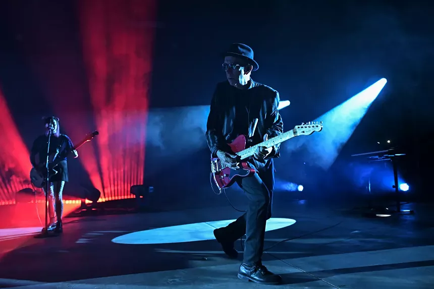 A guitar player performing on stage.