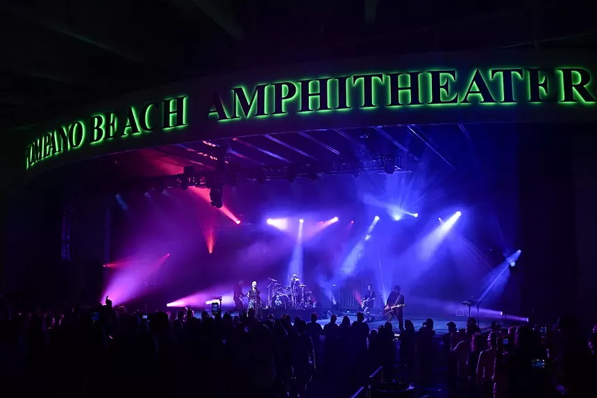 A band performing at the Pompano Beach Amphitheater at night.