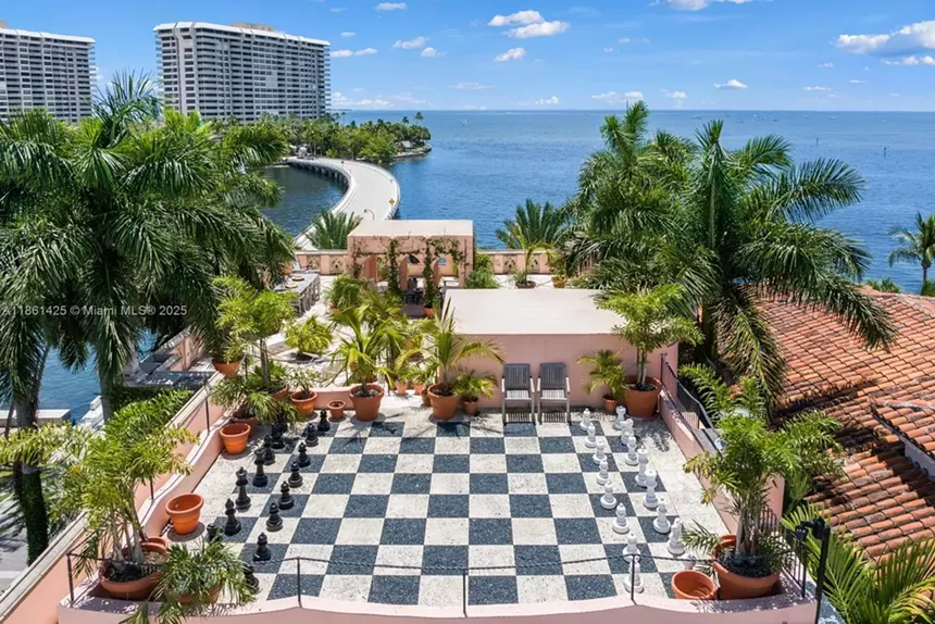 Depicted is a rooftop, life-sized chess board.