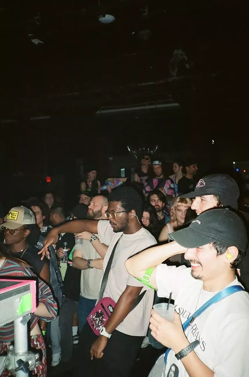A group of people dancing at a rave.