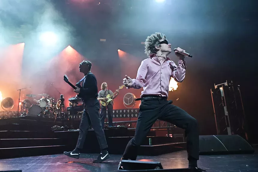 Picture of a rock band performing on stage.