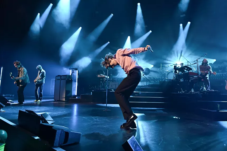 A rock band performing on stage.