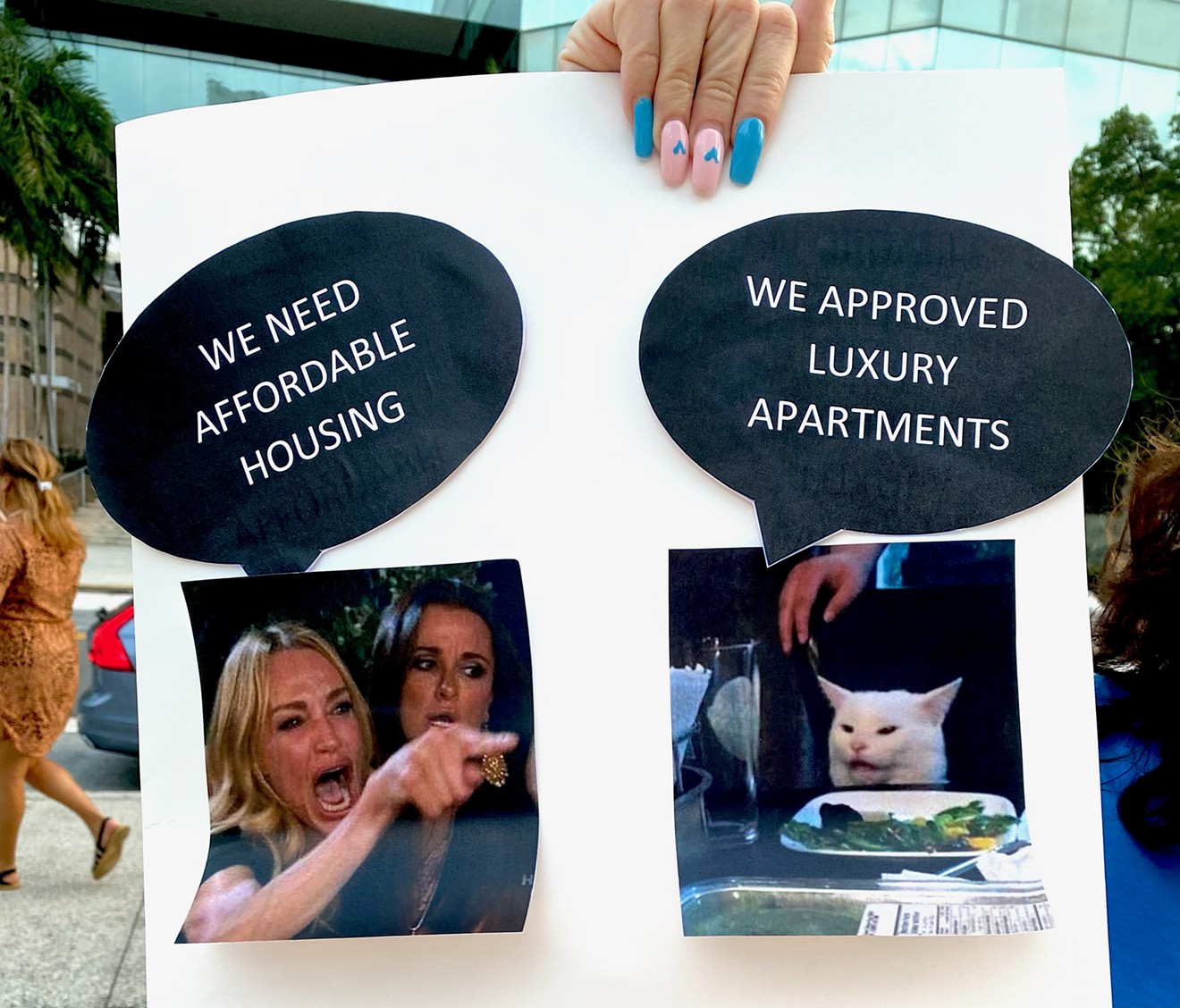 Affordable housing advocates hold signs urging the Fort Lauderdale city commission to prioritize affordable housing.